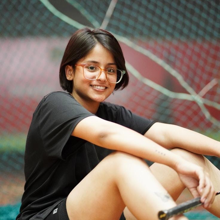 Anaya Rao, Lead Design Curator at ThicketPebbleLumen, reviewing corporate floral arrangements